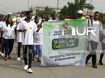 Officials and trainees of the Vocational Training Centre, Federal Nigeria Society for the Blind, Oshodi, participate in a sensitization walk...