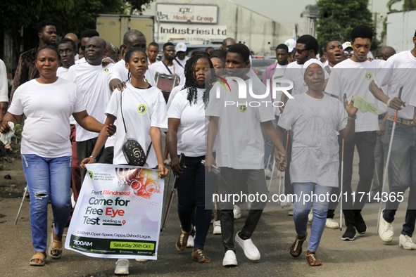 Officials and trainees of the Vocational Training Centre, Federal Nigeria Society for the Blind, Oshodi, participate in a sensitization walk...