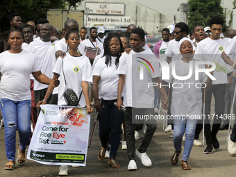 Officials and trainees of the Vocational Training Centre, Federal Nigeria Society for the Blind, Oshodi, participate in a sensitization walk...