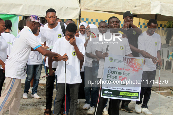 Officials and trainees of the Vocational Training Centre, Federal Nigeria Society for the Blind, Oshodi, participate in a sensitization walk...