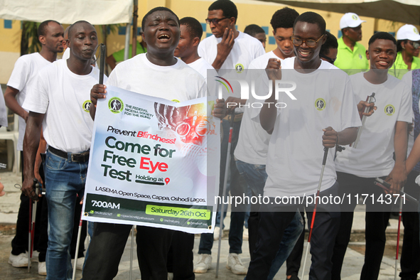 Officials and trainees of the Vocational Training Centre, Federal Nigeria Society for the Blind, Oshodi, participate in a sensitization walk...