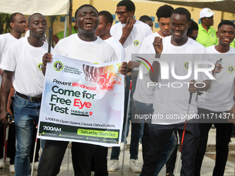 Officials and trainees of the Vocational Training Centre, Federal Nigeria Society for the Blind, Oshodi, participate in a sensitization walk...