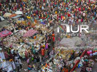 Over a thousand people buy new clothes, home decor, and other accessories in the old market as they throng the shopping hub before the bigge...