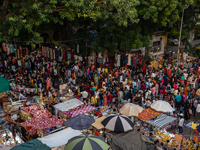 Over a thousand people buy new clothes, home decor, and other accessories in the old market as they throng the shopping hub before the bigge...