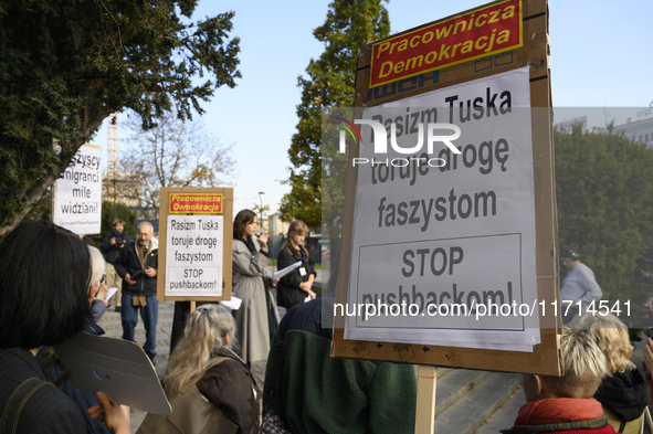 People hold signs that read ''Tusk's racism opens a path to fascists - STOP pushbacks!'' and shout slogans as they rally against the Polish...