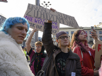 Demonstrators hold a sign that reads ''Ukrainians in solidarity with world's refugees'' and shout slogans as they rally against the Polish P...