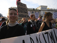 People hold signs that read ''Let in migrants, deport nationalists'' and shout slogans as they rally against the Polish Prime Minister Donal...