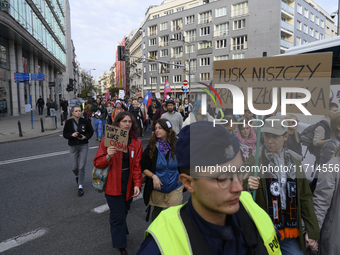 People hold signs that read ''Tusk destroys human rights'' and ''Do not be like Orban'' as they rally against the Polish Prime Minister Dona...