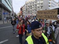 People hold signs that read ''Tusk destroys human rights'' and ''Do not be like Orban'' as they rally against the Polish Prime Minister Dona...