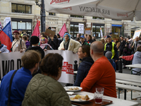 People hold signs and shout slogans as they rally against the Polish Prime Minister Donald Tusk's decision to suspend the right to asylum wi...