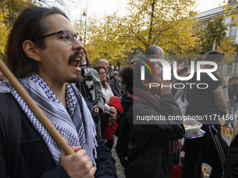 People hold signs and shout slogans as they rally against the Polish Prime Minister Donald Tusk's decision to suspend the right to asylum wi...