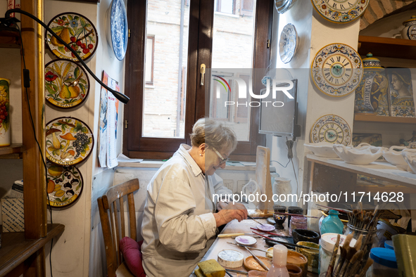 An artisan decorating ceramic object is seen in Deruta, Italy, on October 22nd, 2024. Deruta is the city par excellence of the artistic majo...