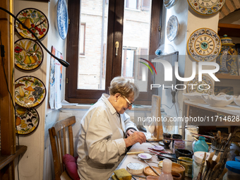 An artisan decorating ceramic object is seen in Deruta, Italy, on October 22nd, 2024. Deruta is the city par excellence of the artistic majo...