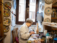 An artisan decorating ceramic object is seen in Deruta, Italy, on October 22nd, 2024. Deruta is the city par excellence of the artistic majo...