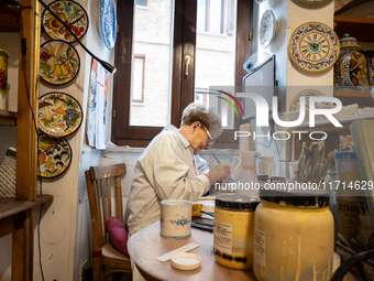 An artisan decorating ceramic object is seen in Deruta, Italy, on October 22nd, 2024. Deruta is the city par excellence of the artistic majo...