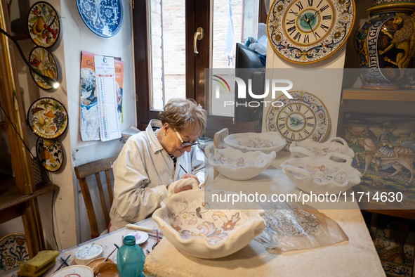 An artisan decorating ceramic object is seen in Deruta, Italy, on October 22nd, 2024. Deruta is the city par excellence of the artistic majo...