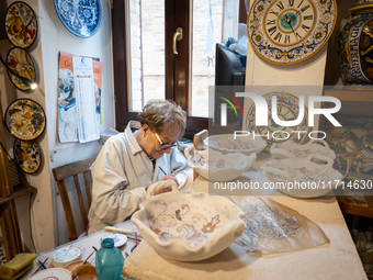 An artisan decorating ceramic object is seen in Deruta, Italy, on October 22nd, 2024. Deruta is the city par excellence of the artistic majo...