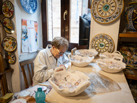 An artisan decorating ceramic object is seen in Deruta, Italy, on October 22nd, 2024. Deruta is the city par excellence of the artistic majo...