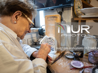 An artisan decorating ceramic object is seen in Deruta, Italy, on October 22nd, 2024. Deruta is the city par excellence of the artistic majo...