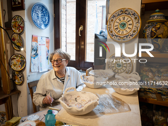 An artisan decorating ceramic object is seen in Deruta, Italy, on October 22nd, 2024. Deruta is the city par excellence of the artistic majo...