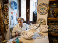 An artisan decorating ceramic object is seen in Deruta, Italy, on October 22nd, 2024. Deruta is the city par excellence of the artistic majo...