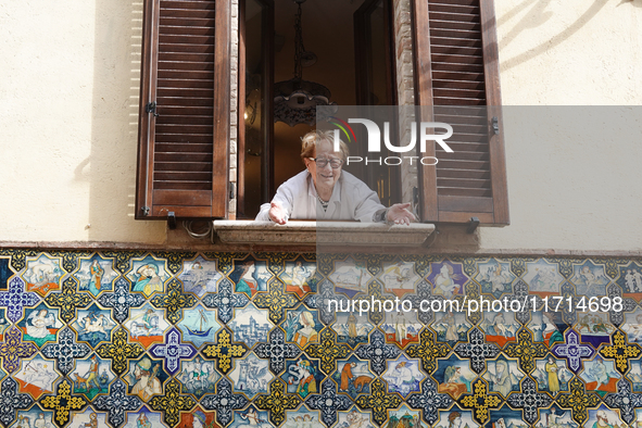 An artisan looking out of the window is seen in Deruta, Italy, on October 22nd, 2024. Deruta is the city par excellence of the artistic majo...