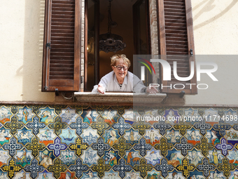 An artisan looking out of the window is seen in Deruta, Italy, on October 22nd, 2024. Deruta is the city par excellence of the artistic majo...