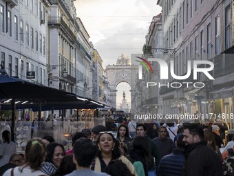 People walk along one of the streets in the Baixa district in Lisbon, Portugal, on October 27, 2024. (