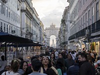 People walk along one of the streets in the Baixa district in Lisbon, Portugal, on October 27, 2024. (