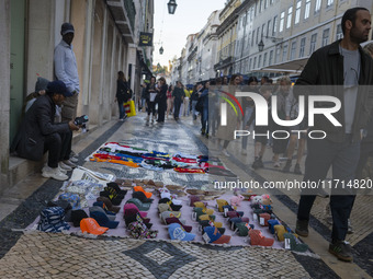 Street vendors sell diverse kinds of goods on one of the streets in the Baixa district in Lisbon, Portugal, on October 27, 2024. (