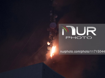 A telecommunication tower is on fire in downtown Tehran, Iran, on October 27, 2024. (