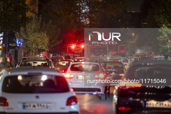 A traffic jam occurs along a street while a telecommunication tower is on fire (not pictured) in downtown Tehran, Iran, on October 27, 2024....