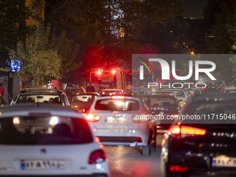 A traffic jam occurs along a street while a telecommunication tower is on fire (not pictured) in downtown Tehran, Iran, on October 27, 2024....