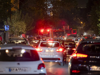 A traffic jam occurs along a street while a telecommunication tower is on fire (not pictured) in downtown Tehran, Iran, on October 27, 2024....