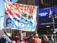 Nadine Seiler holds a sign protesting Donald Trump outside of Madison Square Garden in New York, New York on October 27, 2024 as the former...