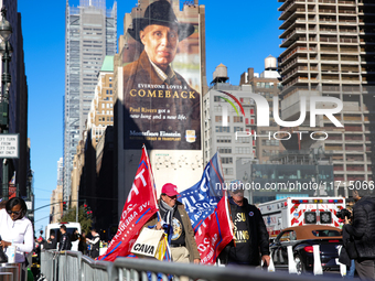 Supporters of Donald Trump carry flags outside of Madison Square Garden in New York, New York on October 27, 2024 as the former President ho...