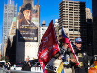 Supporters of Donald Trump carry flags outside of Madison Square Garden in New York, New York on October 27, 2024 as the former President ho...