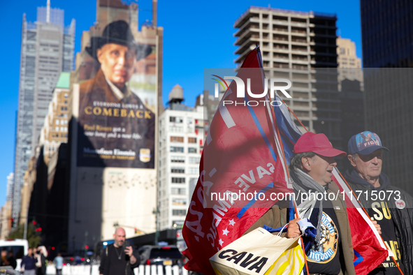 Supporters of Donald Trump carry flags outside of Madison Square Garden in New York, New York on October 27, 2024 as the former President ho...