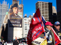 Supporters of Donald Trump carry flags outside of Madison Square Garden in New York, New York on October 27, 2024 as the former President ho...