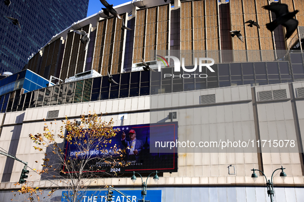 Pigeons fly past a sign outside of Madison Square Garden in New York, New York on October 27, 2024 as former President Donald Trump holds  a...