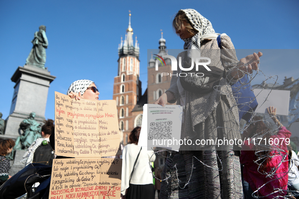 Participants in a protest against the suspension of asylum law under the slogan 'Fuck your borders' gather at the Main Square in Krakow, Pol...