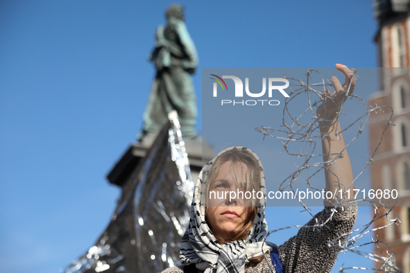 Participants in a protest against the suspension of asylum law under the slogan 'Fuck your borders' gather at the Main Square in Krakow, Pol...