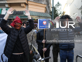 Participants of the counter-demonstration organized by the All-Polish Youth dress as refugees in blackface, and Polish soldiers point rifles...