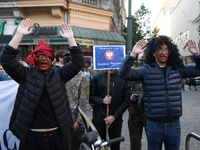 Participants of the counter-demonstration organized by the All-Polish Youth dress as refugees in blackface, and Polish soldiers point rifles...