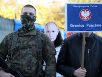 Participants of the counter-demonstration organized by the All-Polish Youth dress up Putin's face during a protest against the suspension of...