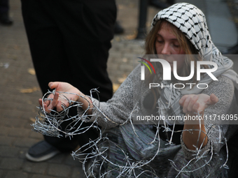 Participants protest against the suspension of asylum law under the slogan 'Fuck your borders' outside the Civic Platform office in Krakow,...