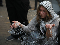 Participants protest against the suspension of asylum law under the slogan 'Fuck your borders' outside the Civic Platform office in Krakow,...