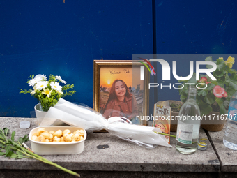 A memorial tribute for a victim of the Itaewon tragedy includes flowers, a framed photo, snacks, and drinks, placed in remembrance in the It...