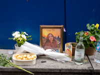 A memorial tribute for a victim of the Itaewon tragedy includes flowers, a framed photo, snacks, and drinks, placed in remembrance in the It...