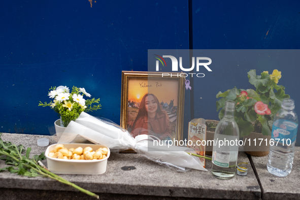 A memorial tribute for a victim of the Itaewon tragedy includes flowers, a framed photo, snacks, and drinks, placed in remembrance in the It...